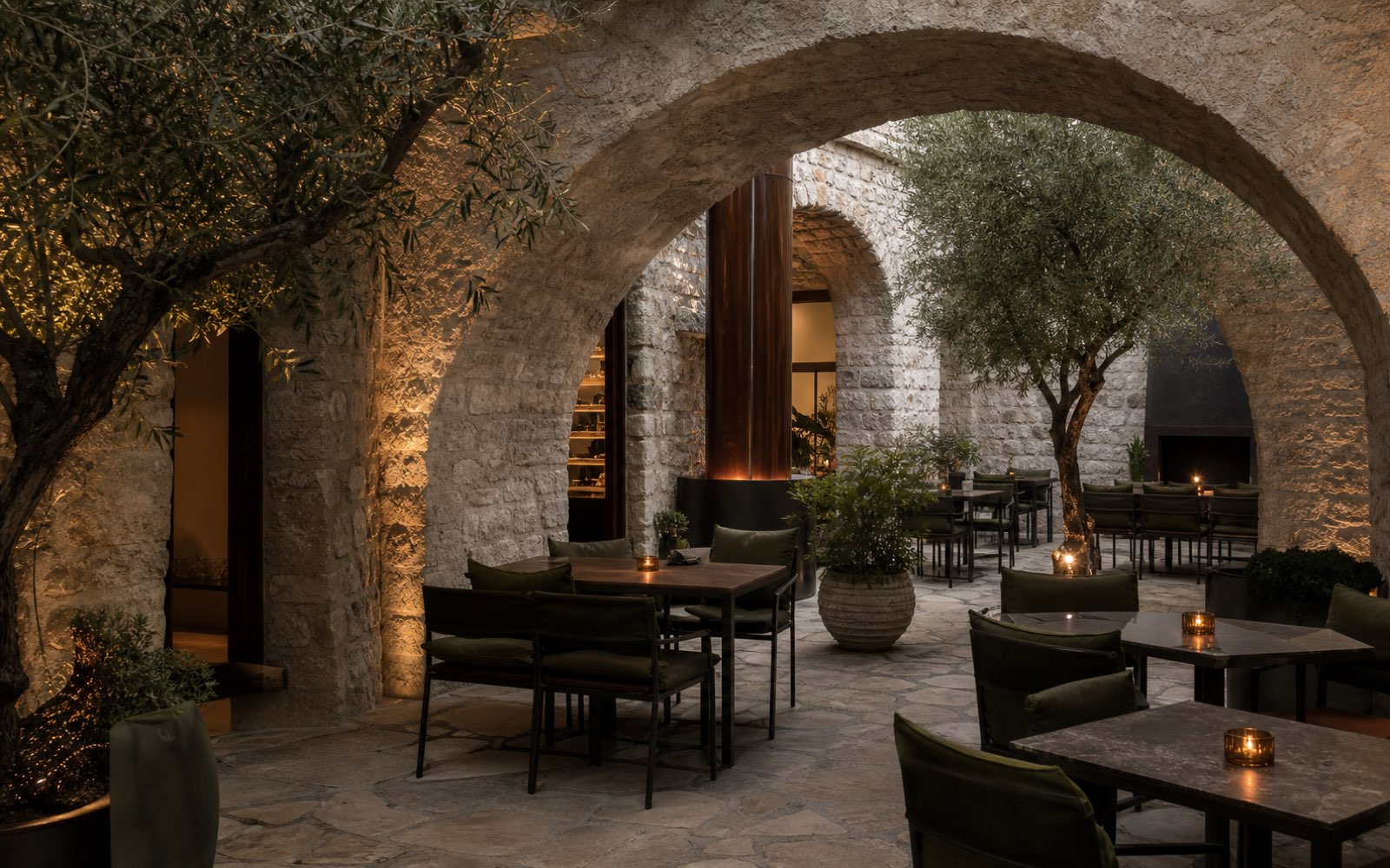 Shaded Ticino courtyard with a table near the fire